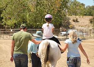 Leading a patient on a horse ride