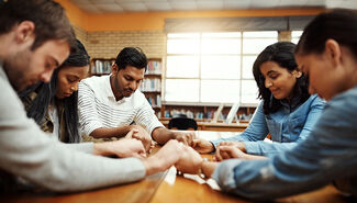 Students praying in Library